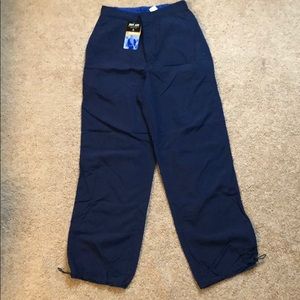 Small blue athletic pants, drawstring bottoms.